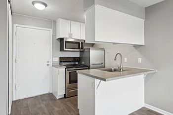 White kitchen with island and stainless appliances